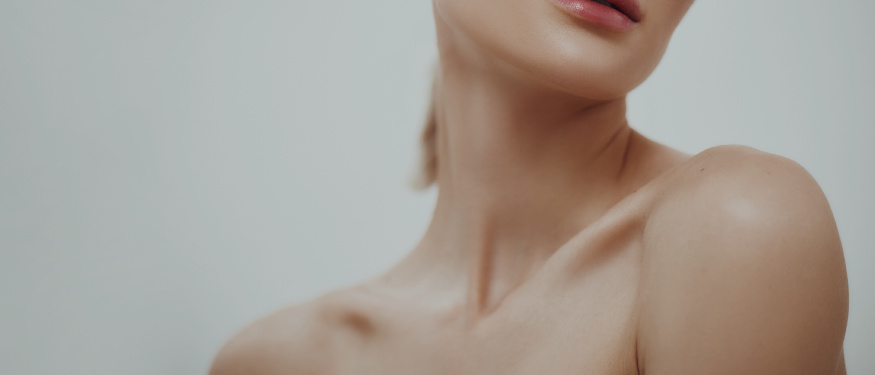 Close-up of a clavicle with shoulder angled forward and soft light on sun-kissed skin.