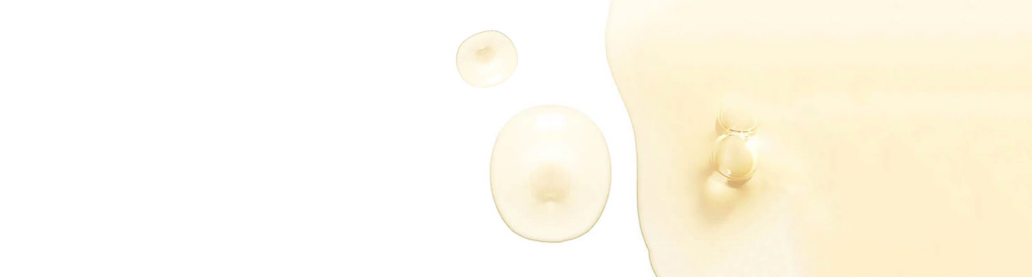 A minimalist image featuring three translucent, beige liquid droplets of varying sizes on a white background. The droplets have soft shadows, giving a three-dimensional effect.