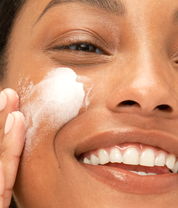 Dr. Loretta Resurfacing Enzyme Polish creamy texture circular motion application closeup of model