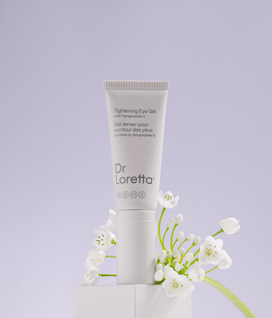 Dr. Loretta Tightening Eye Gel 20ml lifestyle shot of product and flowers image