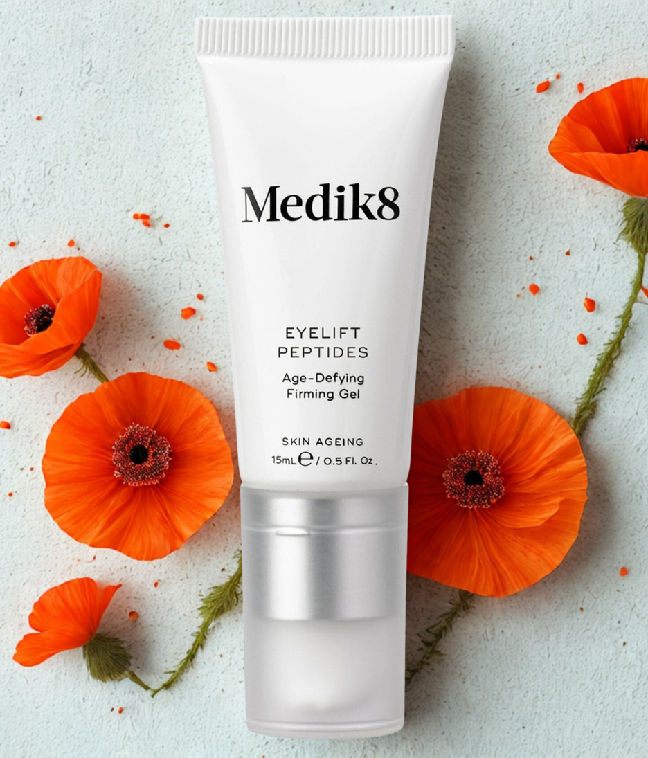 Medik8 eyelift peptides gel tube with orange flowers on a light background