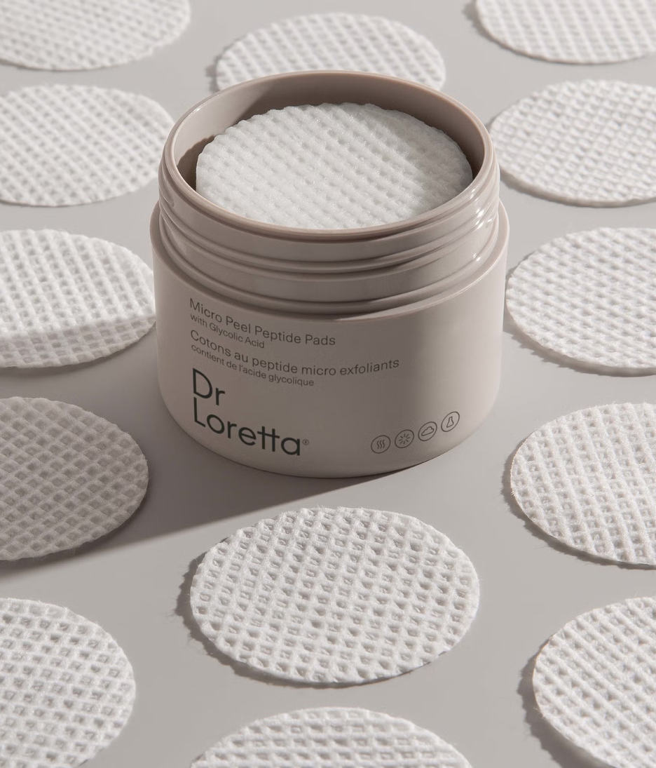 Dr. Loretta Micro Peel Peptide Pads lifestyle image with product and pads close up