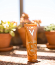 Vichy Capital Soleil Moisturising Self-Tanning Milk face body product shot with lifestyle background